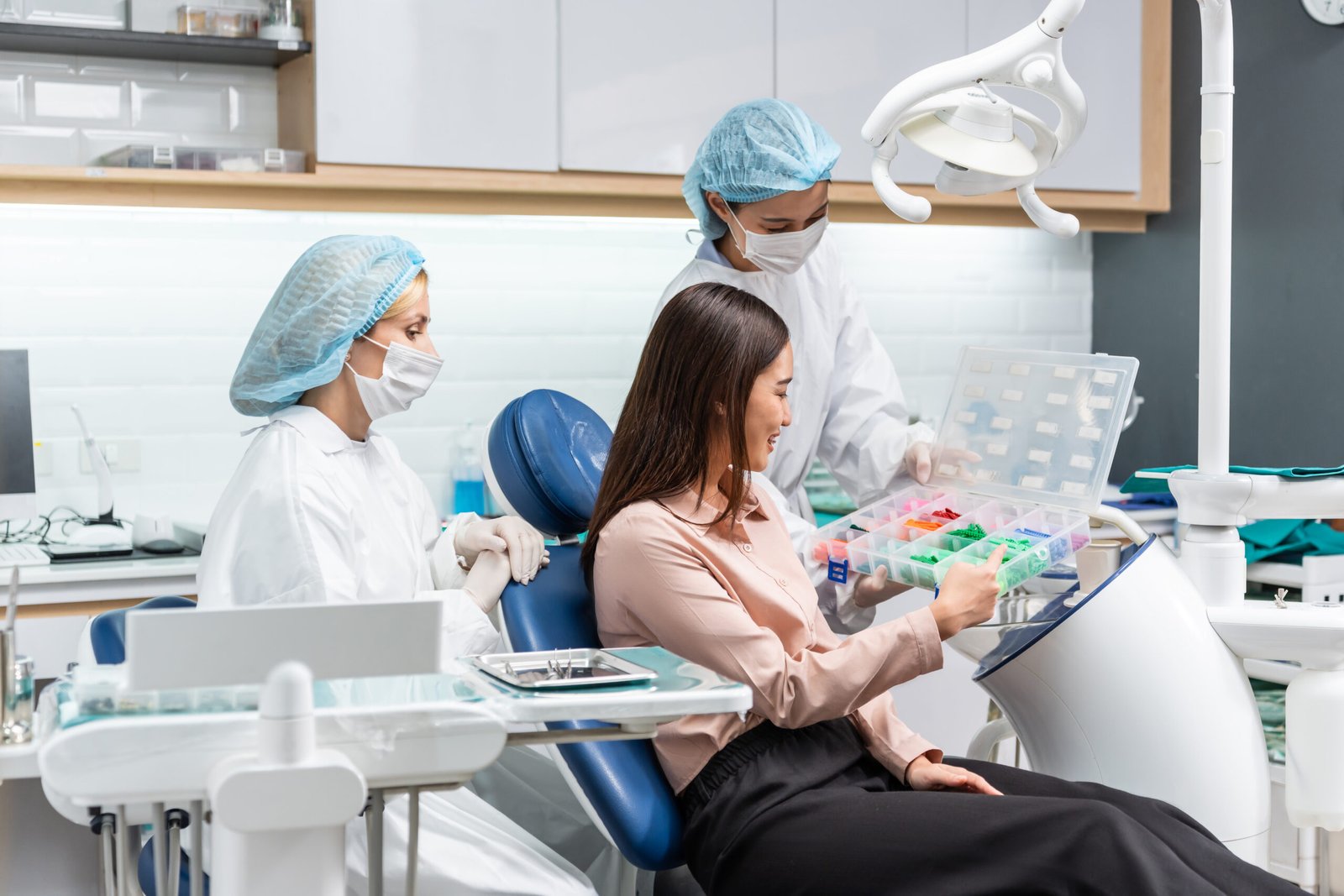 Caucasian dentist examine tooth for young girl at dental health clinic. Attractive woman patient lying on dental chair get dental treatment from doctor during procedure appointment service in hospital